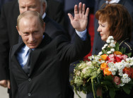 Der russische Präsident Putin winkt bei der Ankunft, daneben seine Frau Ludmila Alexandrowna