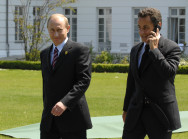 Wladimir Putin und Nicolas Sarkozy (mit Telefon) auf dem Weg zum Strandkorb