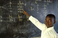 School children in Africa in front of a blackboard 