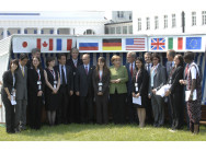 The G8 Heads of State and Government with the J8 delegates in front of a wicker beach chair