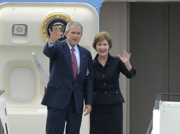 US President George W. Bush and his wife, Laura Bush, wave from the gangway of Airforce One
