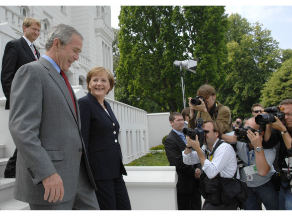 German Chancellor Angela Merkel and US President George W. Bush after their bilateral working lunch on the way to make a press statement in Heiligendamm