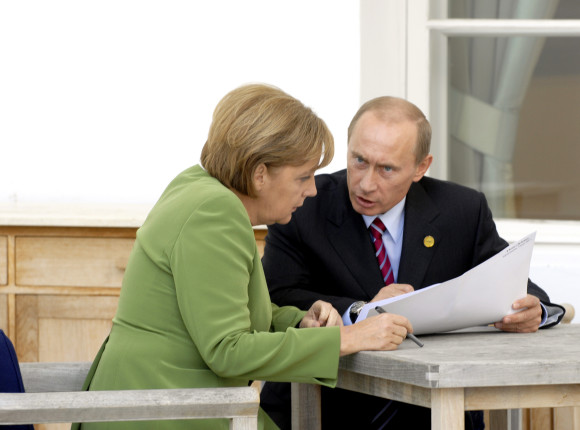German Chancellor Angela Merkel and Russia's President Vladimir Putin talking on the terrace after the working session