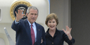 Der amerikanische Präsident George W. Bush und seine Frau Laura winken von der Gangway der Airforce One