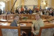 German delegate Janusch Krasberg with Chancellor Merkel in the conference room. 