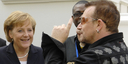 German Chancellor Angela Merkel meets Bono and Bob Geldof on the fringes of the G8 Summit in Heiligendamm